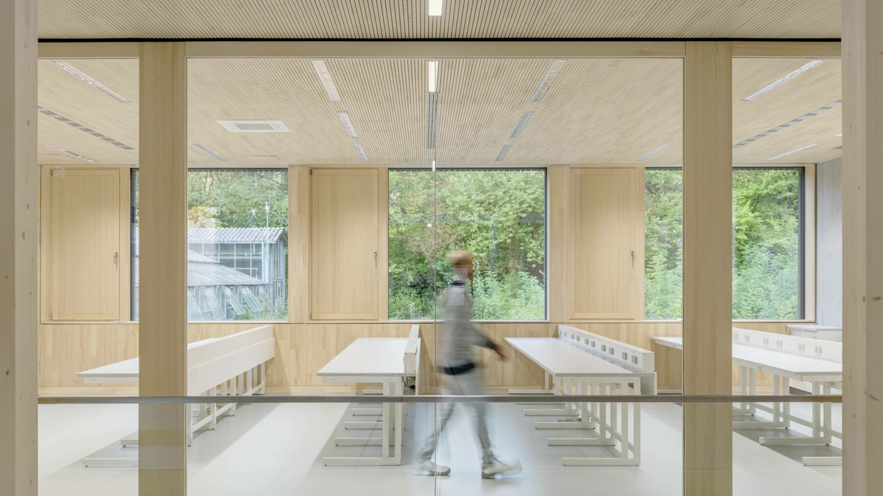 Das gesamte Innenleben des Neubaus wird dominiert durch die riesigen Fensterfronten, die von allen Seiten Licht in die Räume lassen, so auch in dem in helles Holz verkleideten Seminarraum.