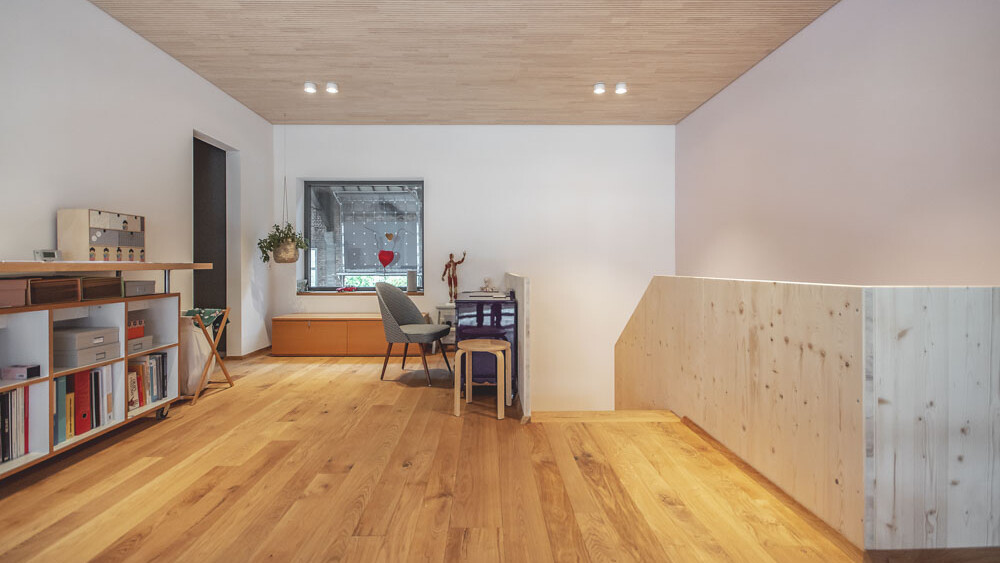 Im geräumigen Obergeschoss dieser Wohnung dienen Holzboden und die edle Profildecke aus Weißtanne als prägende Designelemente und kreieren ein harmonisches Raumbild. 